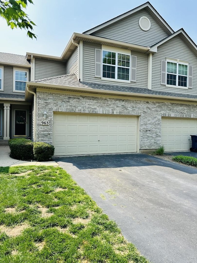 963 Oak Ridge Blvd, Elgin, IL 60120 - view of front facade with asphalt driveway, brick siding, and an attached garage