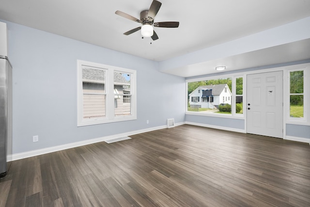 306 Barry Ave, Lockport, IL 60441 - unfurnished living room featuring dark wood-style floors, healthy amount of natural light, and baseboards