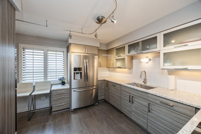 1419 Bonnie Brae Pl Unit 3B, River Forest, IL 60305 - kitchen featuring stainless steel fridge, gray cabinets, tasteful backsplash, glass insert cabinets, and light stone countertops