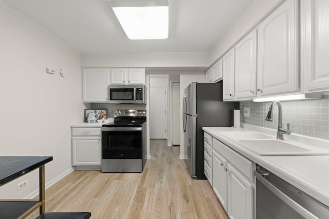 2051 Creekside Dr Unit 2-2, Wheaton, IL 60189 - kitchen with appliances with stainless steel finishes, a sink, decorative backsplash, white cabinetry, and light wood-style flooring