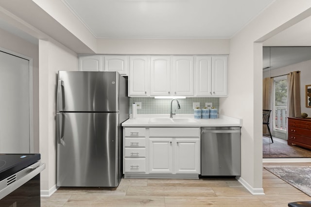 2051 Creekside Dr Unit 2-2, Wheaton, IL 60189 - kitchen with appliances with stainless steel finishes, a sink, light countertops, light wood-style floors, and white cabinetry
