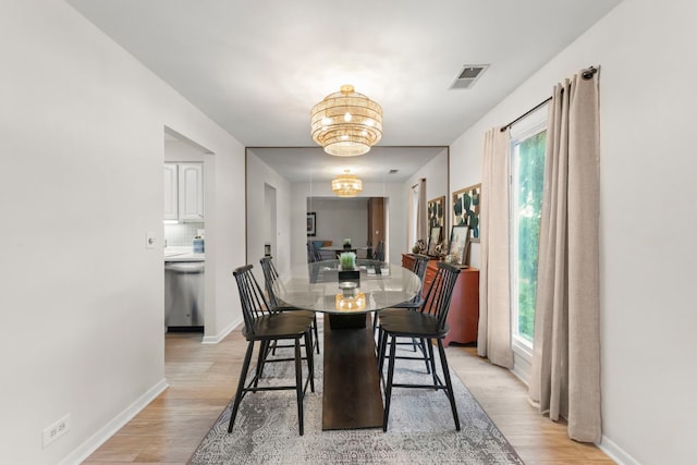 2051 Creekside Dr Unit 2-2, Wheaton, IL 60189 - dining space featuring light wood-type flooring, healthy amount of natural light, a chandelier, and baseboards