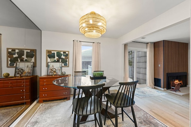 2051 Creekside Dr Unit 2-2, Wheaton, IL 60189 - dining room featuring light wood-style flooring, a chandelier, and a large fireplace