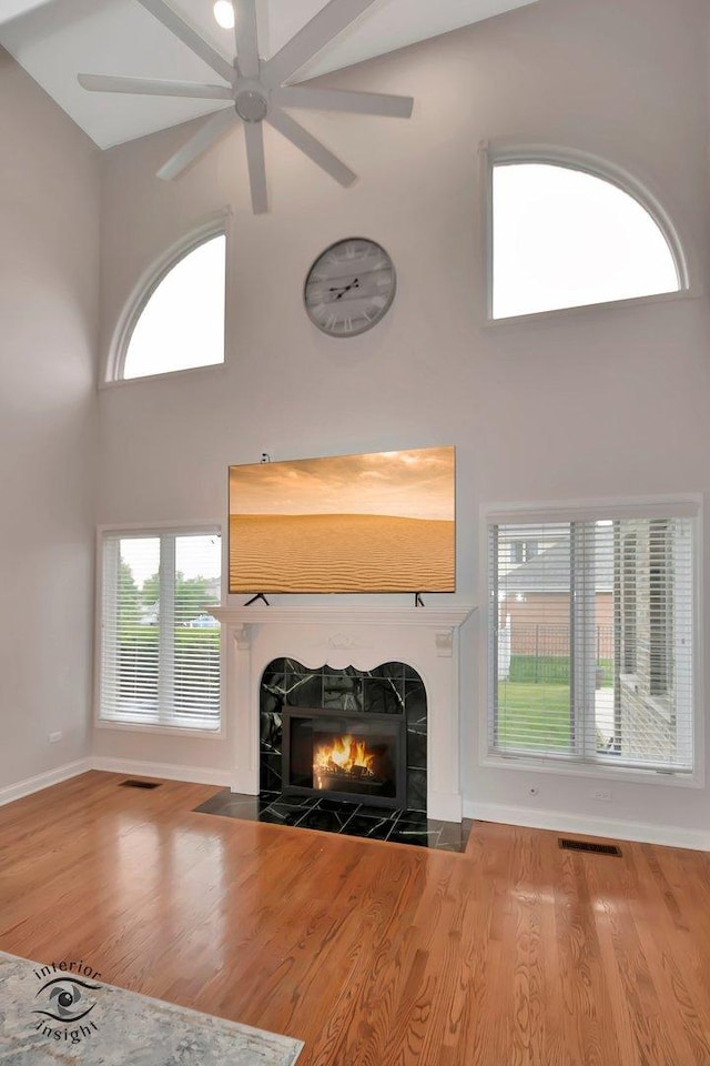 1205 Jennie Dr, New Lenox, IL 60451 - unfurnished living room with a fireplace, a high ceiling, a ceiling fan, wood finished floors, and baseboards