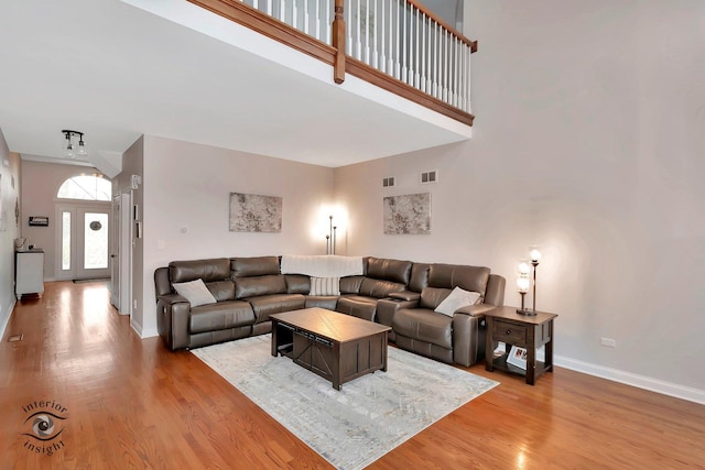 1205 Jennie Dr, New Lenox, IL 60451 - living area with baseboards, light wood-style flooring, and a high ceiling