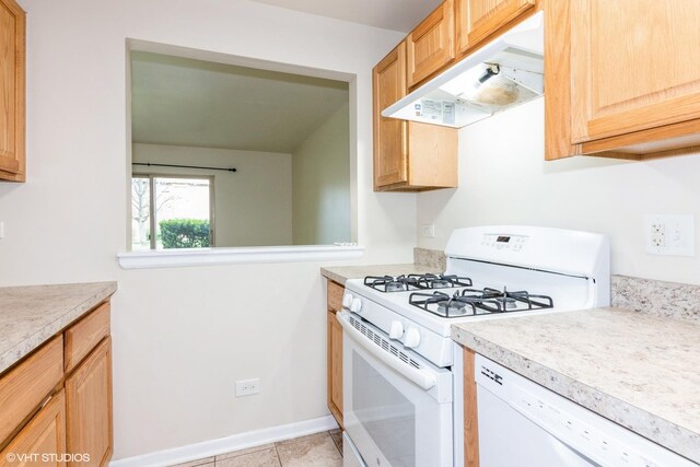 516 N Wilke Rd Unit 105, Palatine, IL 60074 - kitchen featuring white appliances, light countertops, under cabinet range hood, light tile patterned floors, and baseboards