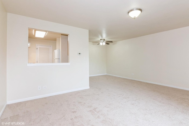 516 N Wilke Rd Unit 105, Palatine, IL 60074 - empty room featuring a ceiling fan, carpet floors, and baseboards