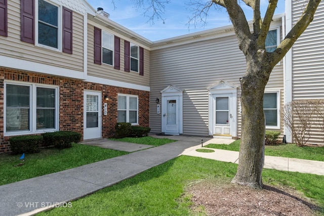 410 Kensington Ct Unit 410, Naperville, IL 60563 - townhome / multi-family property with brick siding and a front lawn