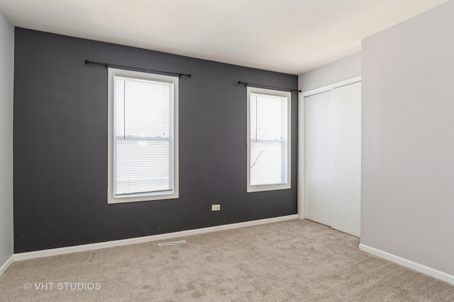 410 Kensington Ct Unit 410, Naperville, IL 60563 - carpeted empty room featuring baseboards