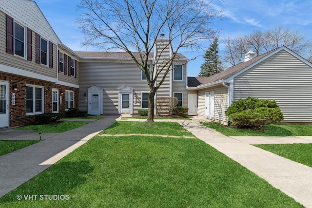 410 Kensington Ct Unit 410, Naperville, IL 60563 - view of front of house featuring a chimney, a front lawn, and roof with shingles