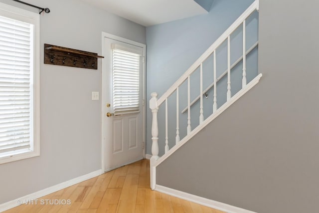 410 Kensington Ct Unit 410, Naperville, IL 60563 - foyer entrance with stairway, wood finished floors, and baseboards