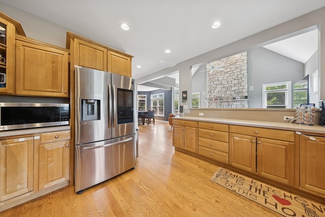 131 N Wilmette Ave, Westmont, IL 60559 - kitchen with stainless steel appliances, light wood finished floors, light countertops, vaulted ceiling, and glass insert cabinets