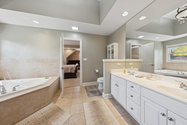131 N Wilmette Ave, Westmont, IL 60559 - ensuite bathroom featuring double vanity, a garden tub, toilet, baseboards, and tile patterned flooring