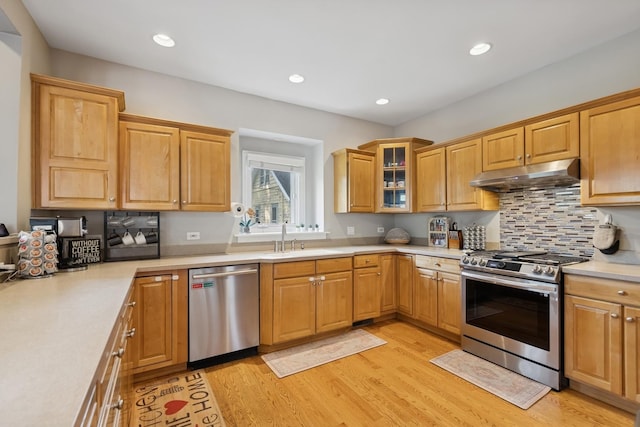 131 N Wilmette Ave, Westmont, IL 60559 - kitchen with appliances with stainless steel finishes, under cabinet range hood, a sink, light wood-type flooring, and light countertops