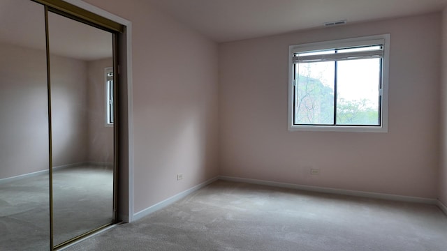 15711 Peggy Ln Unit 7, Oak Forest, IL 60452 - unfurnished bedroom featuring light colored carpet, baseboards, and a closet