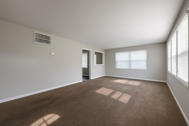 304 Shawnee St, Park Forest, IL 60466 - empty room with dark carpet and baseboards