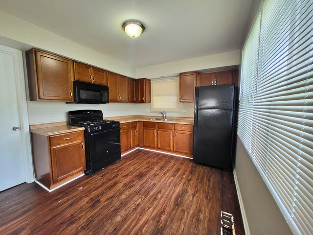 304 Shawnee St, Park Forest, IL 60466 - kitchen with black appliances, light countertops, dark wood-type flooring, and brown cabinets