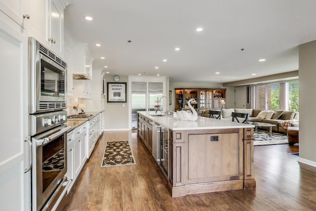 2050 Arbor Ln Unit 301, Northfield, IL 60093 - kitchen featuring built in appliances, recessed lighting, dark wood-style floors, and white cabinets