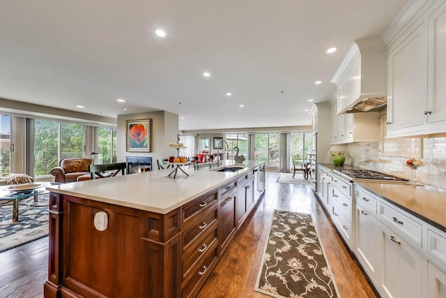 2050 Arbor Ln Unit 301, Northfield, IL 60093 - kitchen featuring recessed lighting, light countertops, a large island, white cabinetry, and dark wood finished floors