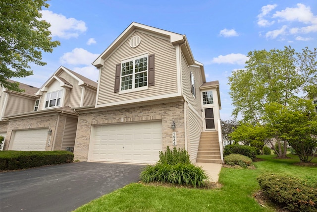 1944 Sundrop Ct Unit 0, Bartlett, IL 60103 - view of front of home with brick siding, driveway, an attached garage, and a front yard