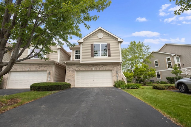 1944 Sundrop Ct Unit 0, Bartlett, IL 60103 - traditional home with asphalt driveway, an attached garage, brick siding, and a front yard