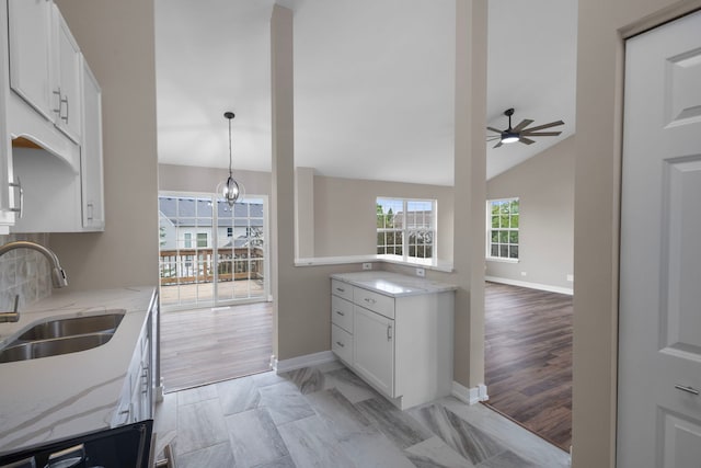 1944 Sundrop Ct Unit 0, Bartlett, IL 60103 - kitchen featuring a sink, ceiling fan, baseboards, and light stone countertops