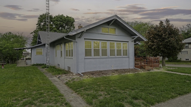 110 E Center St, Mount Morris, IL 61054 - view of side of home featuring a yard, stucco siding, and a chimney