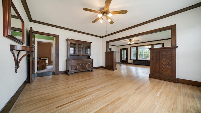 110 E Center St, Mount Morris, IL 61054 - unfurnished living room with light wood finished floors, ceiling fan, baseboards, crown molding, and radiator heating unit