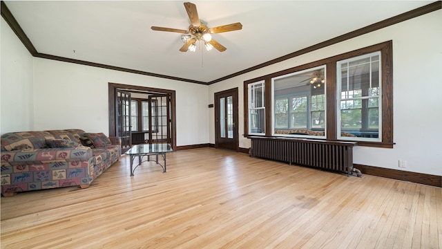 110 E Center St, Mount Morris, IL 61054 - living area with radiator, wood-type flooring, a ceiling fan, crown molding, and baseboards