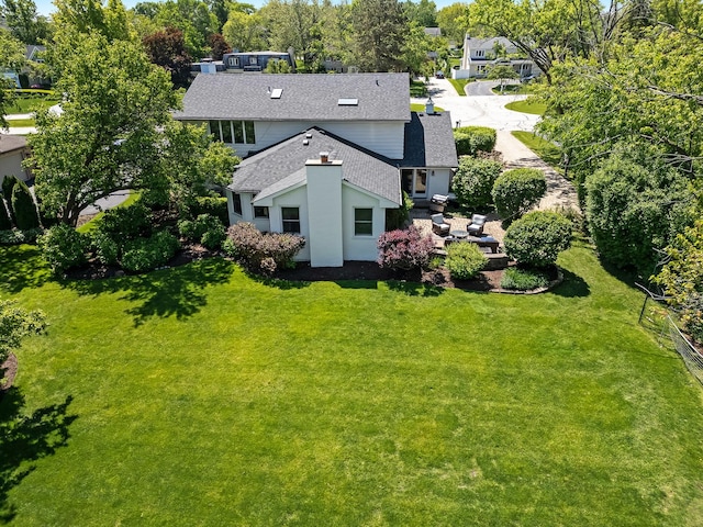 9 Charleston Rd, Hinsdale, IL 60521 - back of property featuring a shingled roof and a lawn