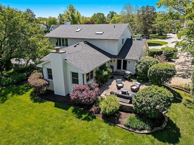 9 Charleston Rd, Hinsdale, IL 60521 - rear view of house featuring roof with shingles, a lawn, a deck, and a chimney