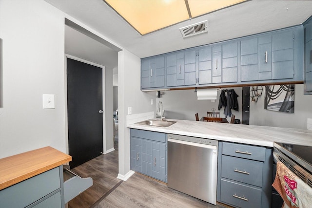 820 Elder Rd Unit C412, Homewood, IL 60430 - kitchen with stainless steel appliances, a sink, blue cabinets, light wood-style flooring, and light countertops