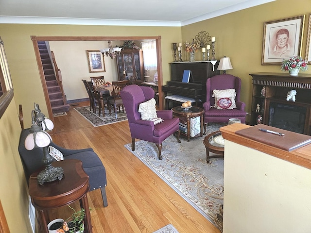 928 S Hillcrest Ave, Elmhurst, IL 60126 - living room with a chandelier, wood finished floors, a fireplace, and ornamental molding