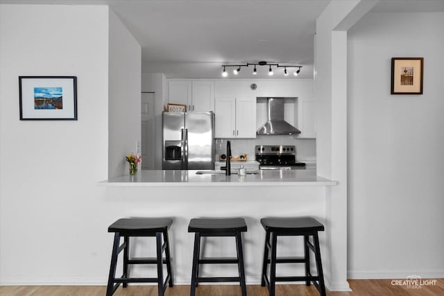 345 N La Salle Dr Unit 3507, Chicago, IL 60654 - kitchen with wall chimney range hood, stainless steel appliances, a sink, and a peninsula