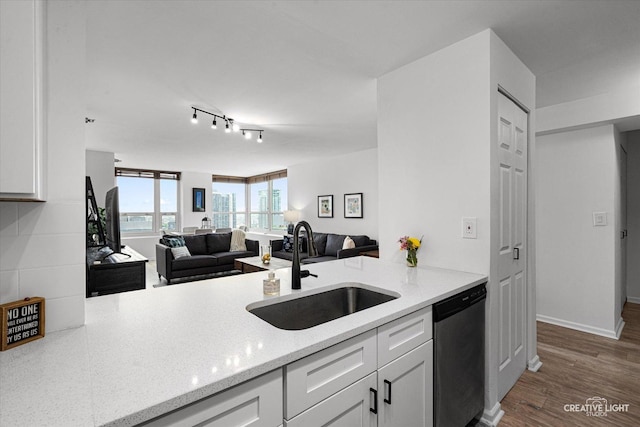 345 N La Salle Dr Unit 3507, Chicago, IL 60654 - kitchen featuring stainless steel dishwasher, a sink, white cabinets, open floor plan, and light stone counters