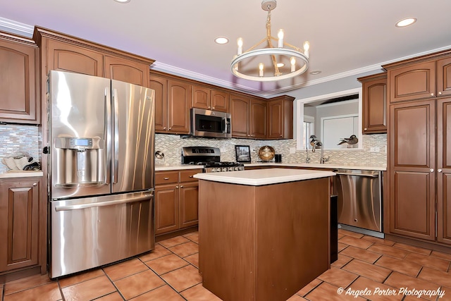 41653 N Lotus Ave, Antioch, IL 60002 - kitchen featuring appliances with stainless steel finishes, a chandelier, backsplash, light countertops, and a center island