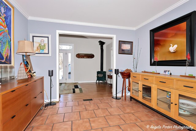 41653 N Lotus Ave, Antioch, IL 60002 - interior space with a wood stove, ornamental molding, and light tile patterned floors
