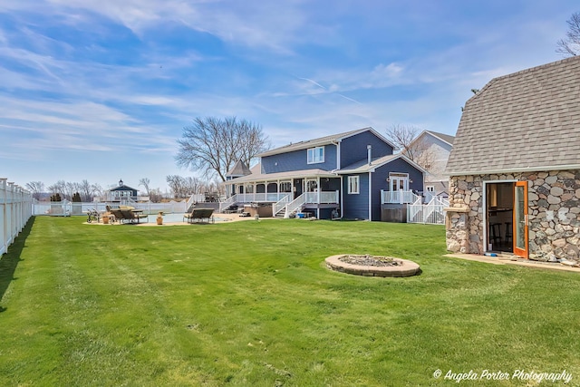 41653 N Lotus Ave, Antioch, IL 60002 - rear view of house featuring an outdoor fire pit, a fenced backyard, stairway, and stone siding