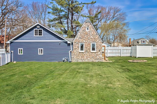 41653 N Lotus Ave, Antioch, IL 60002 - rear view of house with a fenced backyard and stone siding