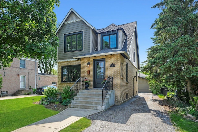 734 Forest Rd, La Grange Park, IL 60526 - view of front facade with brick siding, a front lawn, a detached garage, and a shingled roof