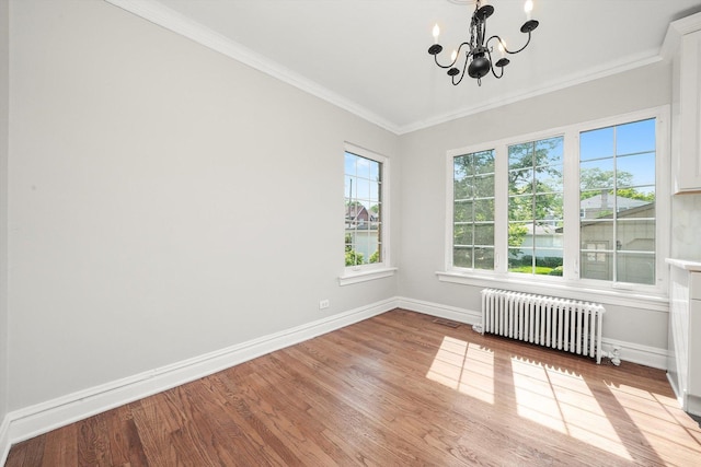 734 Forest Rd, La Grange Park, IL 60526 - unfurnished room with radiator heating unit, a chandelier, baseboards, wood finished floors, and crown molding