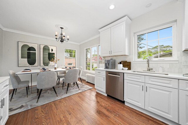 734 Forest Rd, La Grange Park, IL 60526 - kitchen with stainless steel dishwasher, a chandelier, a sink, light wood finished floors, and light countertops