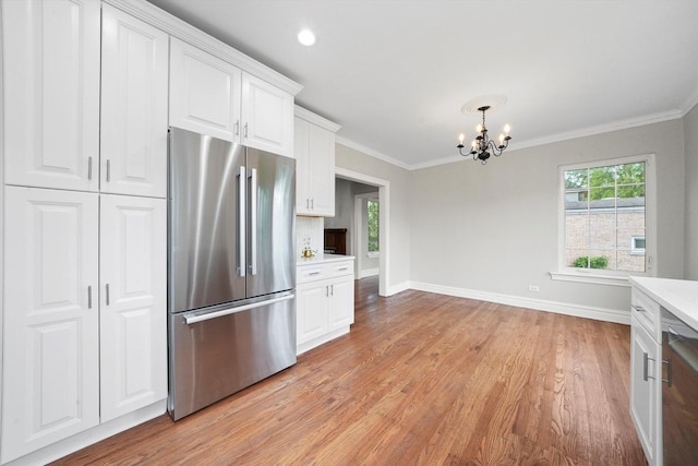 734 Forest Rd, La Grange Park, IL 60526 - kitchen with high end fridge, a chandelier, light wood-style floors, crown molding, and white cabinetry