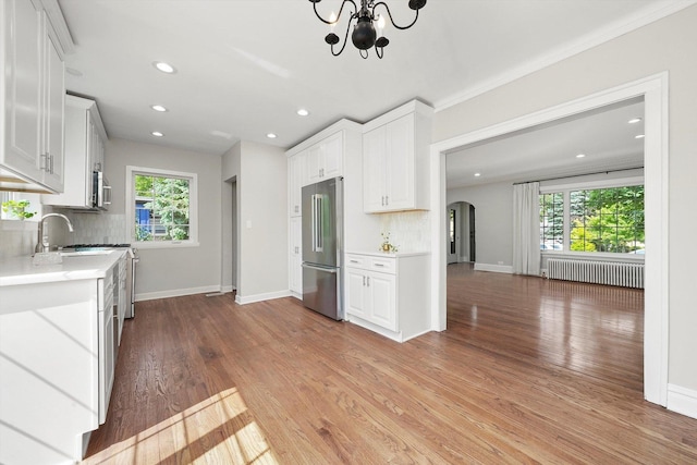 734 Forest Rd, La Grange Park, IL 60526 - kitchen featuring appliances with stainless steel finishes, radiator, light countertops, plenty of natural light, and recessed lighting