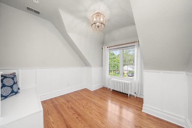 734 Forest Rd, La Grange Park, IL 60526 - bonus room featuring radiator, lofted ceiling, wood finished floors, a chandelier, and a decorative wall