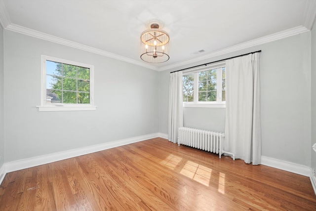 734 Forest Rd, La Grange Park, IL 60526 - spare room featuring radiator, a chandelier, baseboards, light wood-style flooring, and ornamental molding