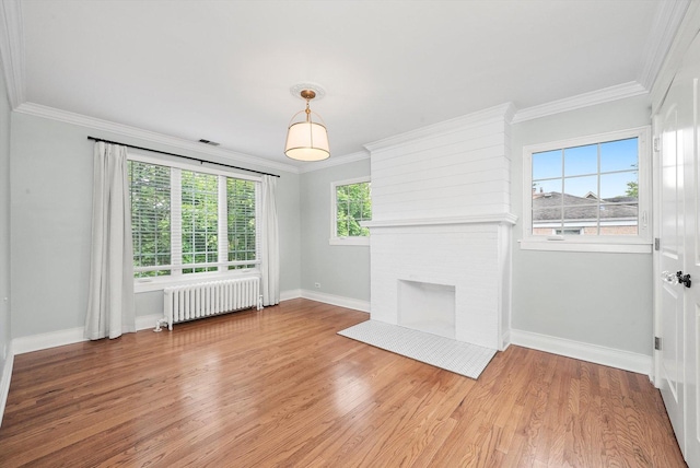 734 Forest Rd, La Grange Park, IL 60526 - unfurnished living room with radiator heating unit, baseboards, light wood-style floors, a fireplace, and crown molding