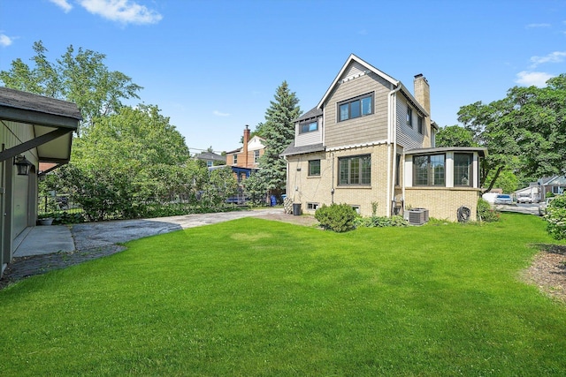 734 Forest Rd, La Grange Park, IL 60526 - rear view of property with brick siding, cooling unit, and a shingled roof