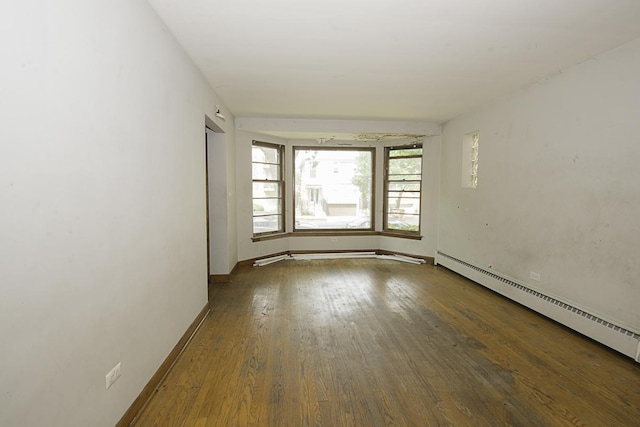 4033 N Austin Ave, Chicago, IL 60634 - empty room with a baseboard heating unit, wood finished floors, and baseboards