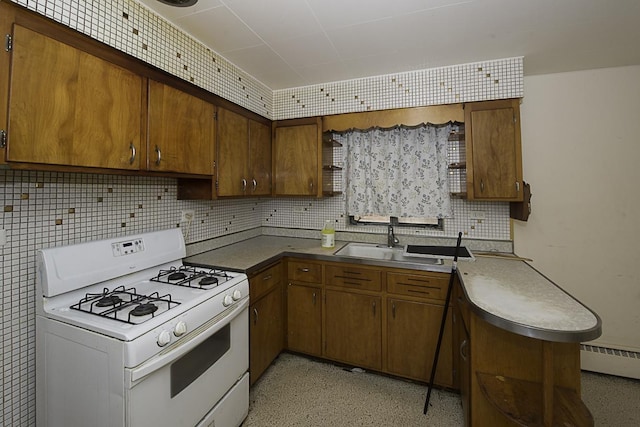 4033 N Austin Ave, Chicago, IL 60634 - kitchen with white gas stove, baseboard heating, backsplash, a sink, and brown cabinetry